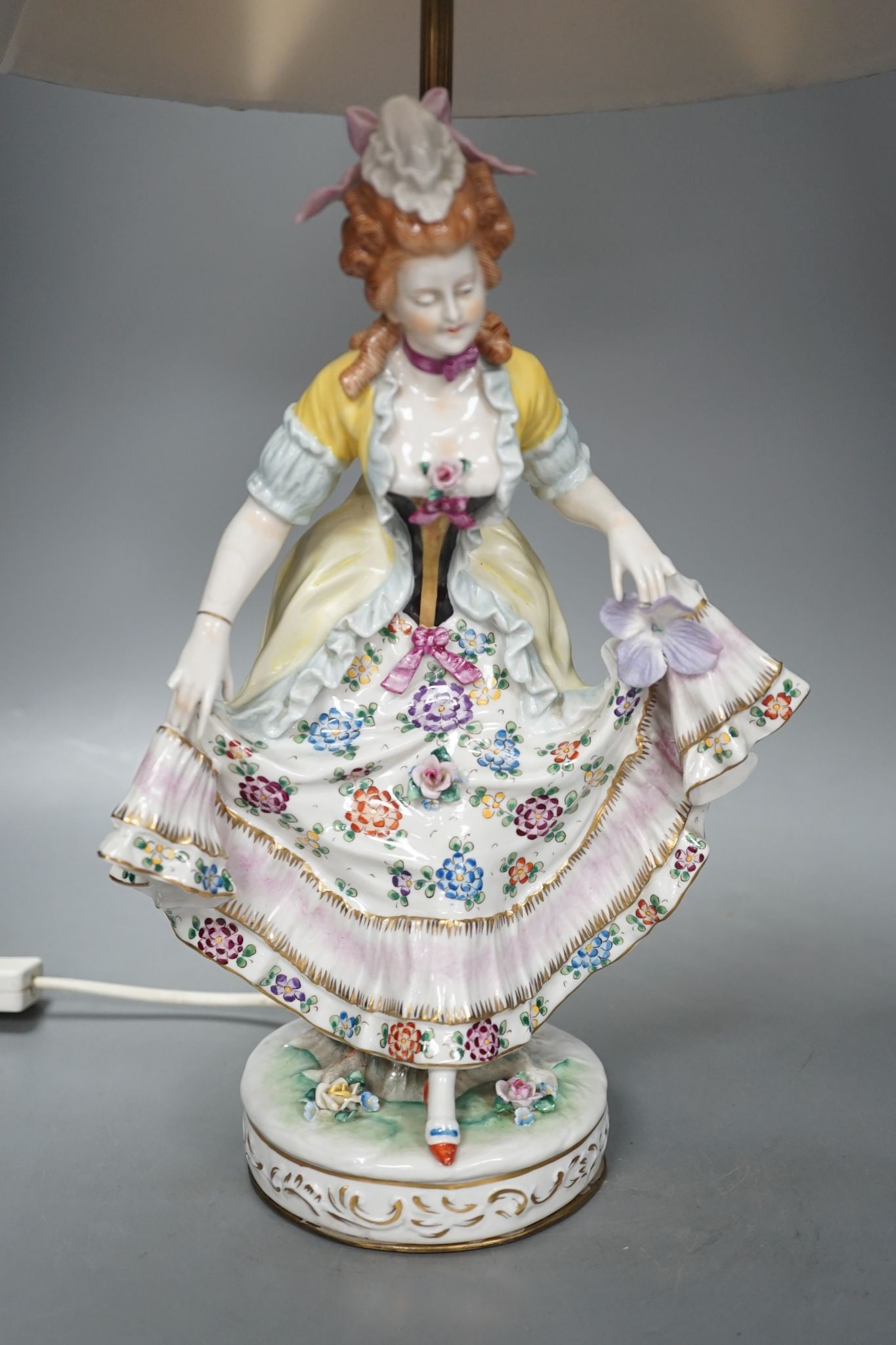 A German porcelain ‘dancing lady’ lamp, figure 29 cms high.